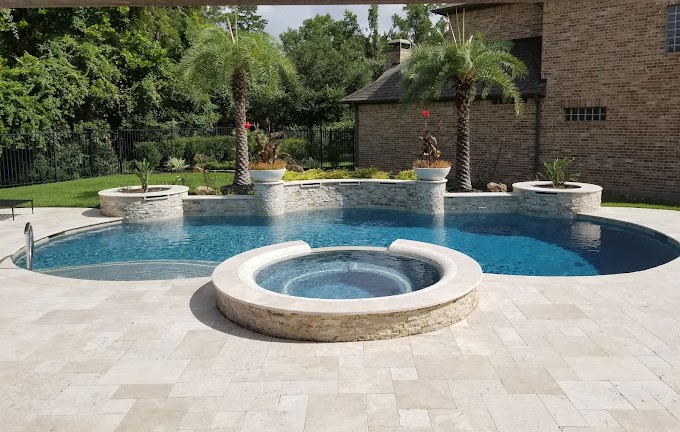 luxury pool with hot tub and palm trees